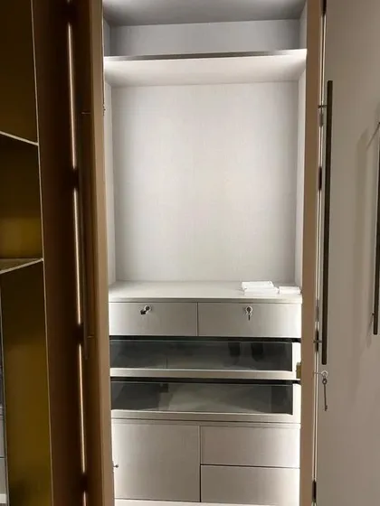 The interior of another bespoke wardrobe, featuring glass-fronted drawers and custom compartments. I can incorporate various accessories and lighting to make your storage both functional and beautiful.