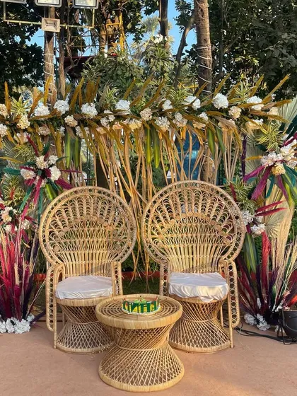 A chic bohemian-style seating arrangement for a Mehendi or bridal shower. The peacock chairs and pampas grass decorations create a trendy and relaxed vibe.