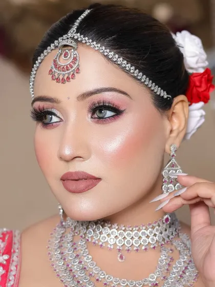 This side profile shot shows off the highlighter and the sharp winged liner, demonstrating the student's technical precision.