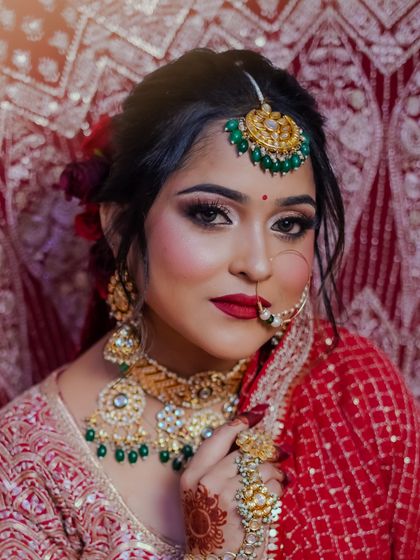 A classic pose with the veil, highlighting the bride's stunning features and the detailed makeup.
