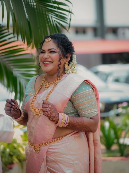 A candid shot of the bride sharing a laugh during her engagement ceremony. This photo captures her natural beauty and the genuine happiness of the moment.