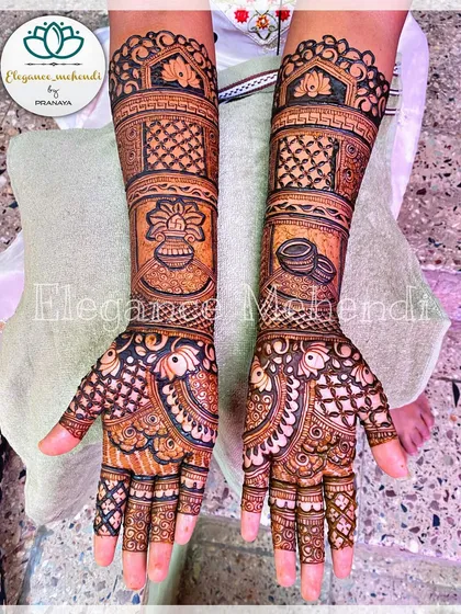 A clear shot of a completed bridal mehendi, showcasing the symmetry and detail in the patterns on both hands.