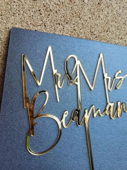 A "Mr & Mrs Beayman" topper in a unique, modern font, showing the versatility of my custom designs.