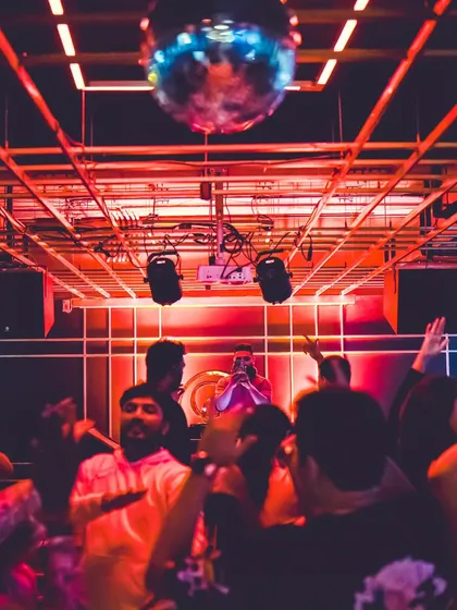 A sea of hands in the air under the red lights at Gawky Goose. This is the response I aim for, creating a unified, high-energy experience on the dance floor.