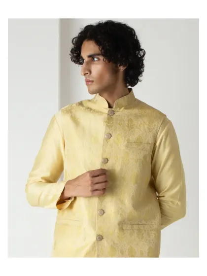A closer view of the yellow bundi set, highlighting the fine fabric and precise button placement. It's a versatile piece for any man's festive wardrobe.