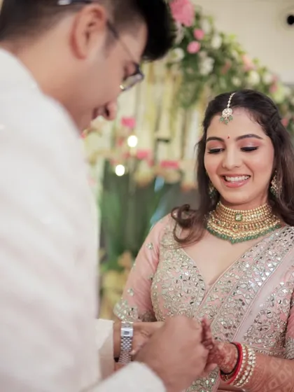 A precious moment between the couple during their engagement ceremony. Her radiant makeup looks flawless and natural up close.