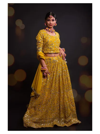 Capturing the joy and vibrancy of festive wear is one of my specialties. This full-length shot of a yellow lehenga uses studio lighting to highlight the intricate mirror work and the beautiful flow of the fabric, perfect for a bridal or celebration collection.