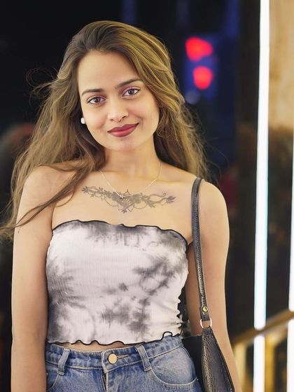 A guest with a beautiful tattoo, posing for a photo.