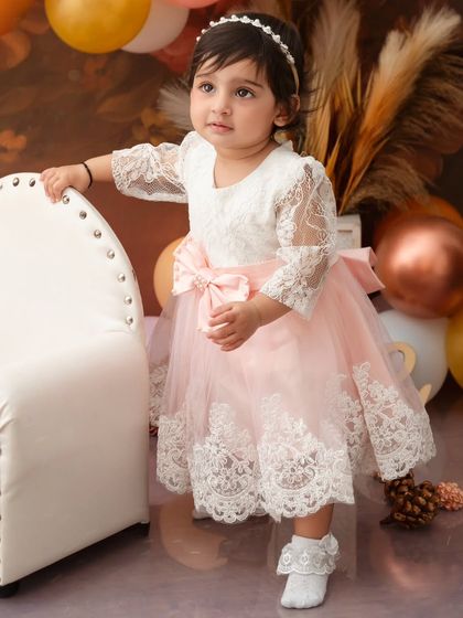 Wrapped in petals, dressed in light. This little girl looks like a princess in her beautiful lace and tulle dress.