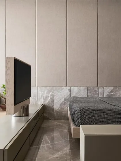 This versatile guest room in Project Acropolis doubles as a family room. We designed a central console with a rotating television that can serve either the seating area or the bed, creating a truly multifunctional space without compromising on style.