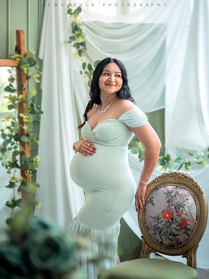 Using elegant studio furniture like this vintage chair adds a touch of sophistication to your maternity portraits.