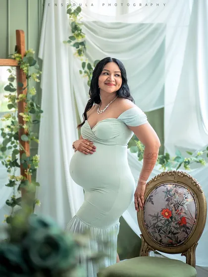 Using elegant studio furniture like this vintage chair adds a touch of sophistication to your maternity portraits.