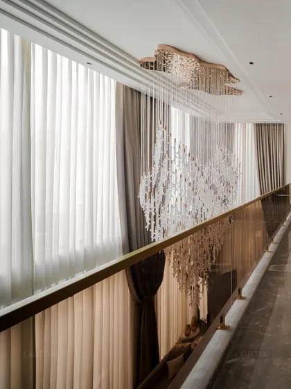 The joy is in the little details. This cascading chandelier is more than a light fixture; it's the heart of this double-height space, transforming a simple corridor into an experience of light and movement. We focus on these bespoke elements that make a home feel truly special.