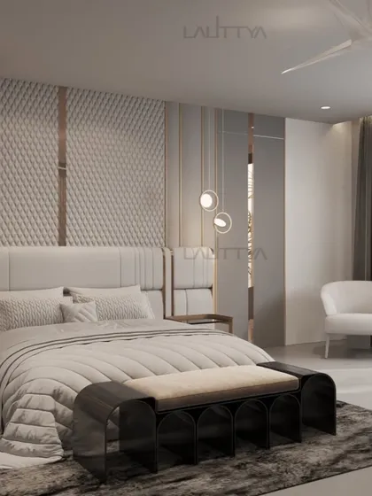 A seamless blend of modern luxury and soft textures. This sophisticated bedroom features quilted wall panels, metallic accents, and plush furnishings, offering a refined and contemporary retreat.