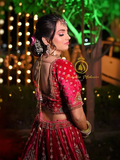 A view of the back of the blouse and the elegant hair bun. The deep V-back of the blouse adds a modern touch to the traditional velvet lehenga.