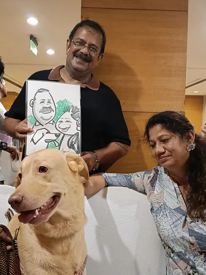 A couple and their dog with their family caricature at a pet-friendly event in Mumbai, organized by OnePlus.