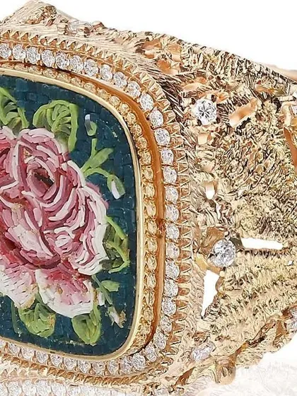 This micromosaic rose ring is set in a uniquely textured 18k gold band, designed to look like woven lace. The detailed craftsmanship of the band complements the delicate mosaic art, creating a truly one of a kind statement piece.