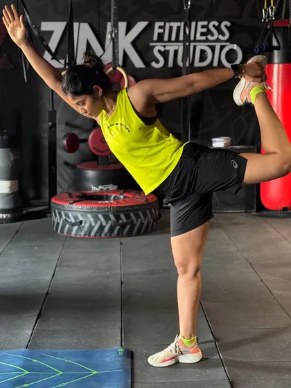 Fitness is also about balance, strength, and control. Here's a moment of focus, showing a dancer's pose that helps improve stability and flexibility, which we build in all our classes.