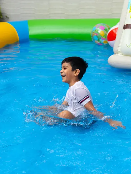 This happy kiddo is having the time of his life making a splash in our pool. These are the carefree summer moments I love to create for families.