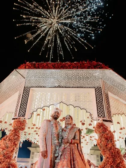 The grand finale of the varmala. A stunning fireworks display crowns the couple under their beautiful mandap, marking the perfect end to the ceremony.