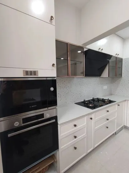 A duplicate of the hero image 69, showing the tall unit with a built-in oven and microwave, a hallmark of a modern, high-end kitchen.