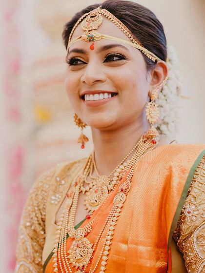 A radiant smile from a beautiful South Indian bride. Her happiness is infectious, and we made sure to capture it in this candid, joyful portrait.