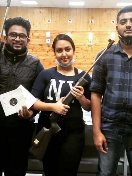 This group of three just finished their session, with one guest proudly showing off her impressive target sheet. It's that moment of hitting the mark that gets people hooked.