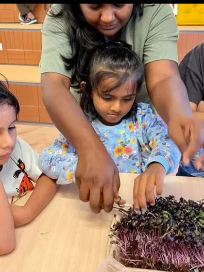 An instructor guides children as they learn about microgreens. We believe in hands on learning to connect kids with the food they eat.