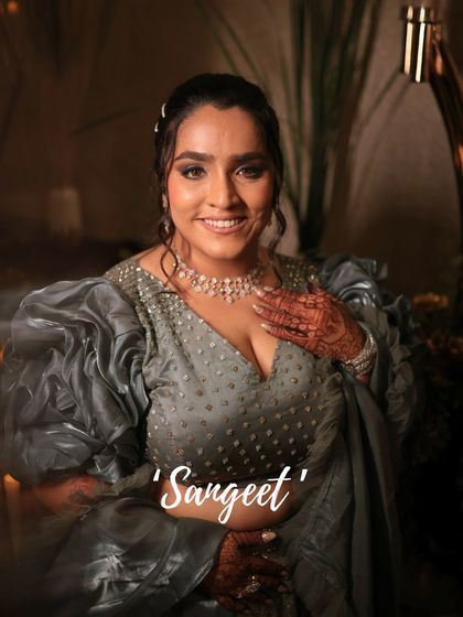 For her Sangeet, this bride chose a dramatic look with a smokey eye and a nude lip, perfectly complementing her fashion-forward puff-sleeve blouse.