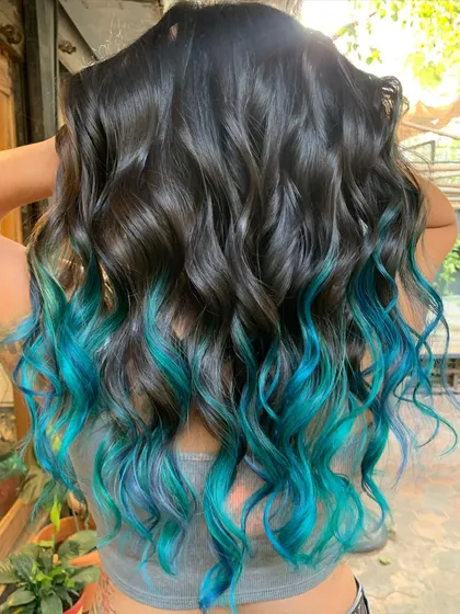 She’s got the ocean tucked in her hair. This turquoise dip dye is for anyone ready to embrace their inner mermaid. This is a bleach color, of course. (No filter)