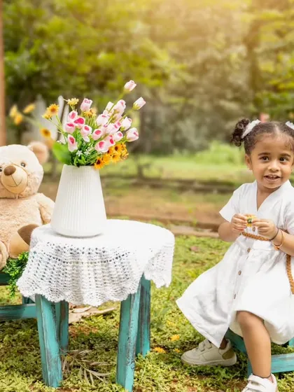 A delightful outdoor kids' photoshoot with a teddy bear picnic theme. Using natural light and a fun setup, I create a relaxed environment for children to play and express their personalities.