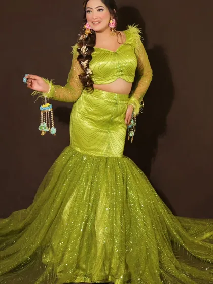 The full view of the lime green fish-cut lehenga. The sequined skirt adds glamour, making it a great choice for a Mehendi or Sangeet night.