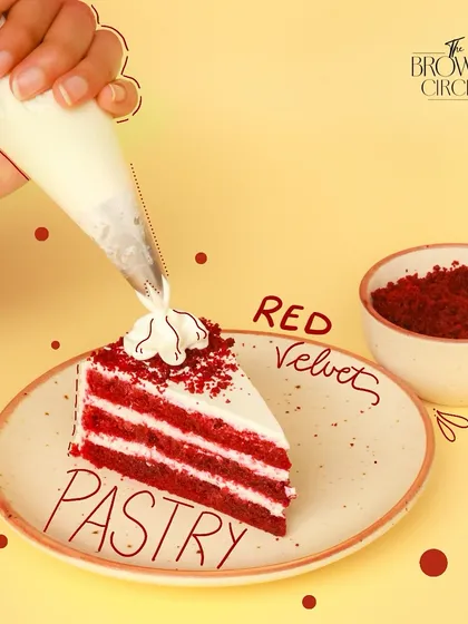 A perfect slice of my Red Velvet Pastry. You can see the distinct, moist layers of cake balanced with the light, tangy cream cheese frosting. Each slice is finished by hand with a sprinkle of red velvet crumbs.