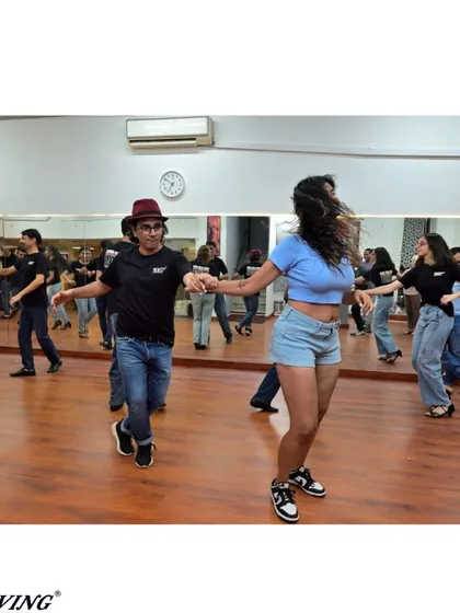 A fun moment of connection during a partner rotation in our Salsa class. We believe dancing is about building community.