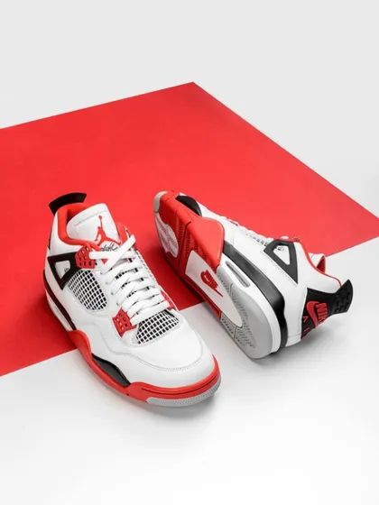 A duplicate of image 107, this clean shot uses a two-tone red and white background to make the sneakers pop. The composition is graphic and bold, perfect for capturing attention on a busy webpage.