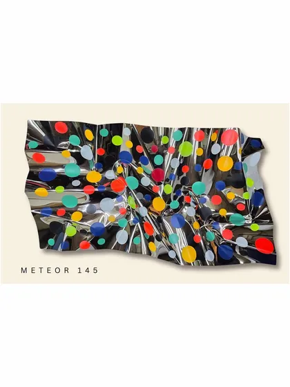 From my Meteor series, this wall installation explores energy and joy. The reflective, crumpled steel surface is scattered with vibrant polka dots, creating a playful and dynamic piece that interacts with the light in the room.