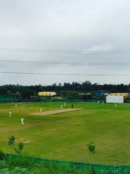 A full view of our professional-grade cricket ground during a match. We believe in testing skills in real match situations, not just in the nets.