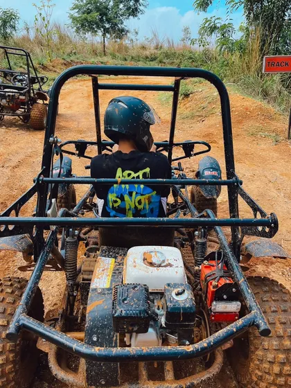 A view from the driver's seat of a dirt kart, ready to take on the challenging off-road track.