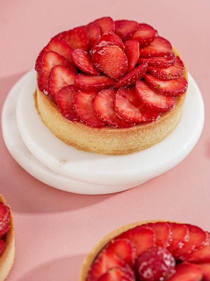 Our individual Strawberry Tart, featuring a buttery crust filled with cream and topped with a perfect spiral of fresh strawberries.