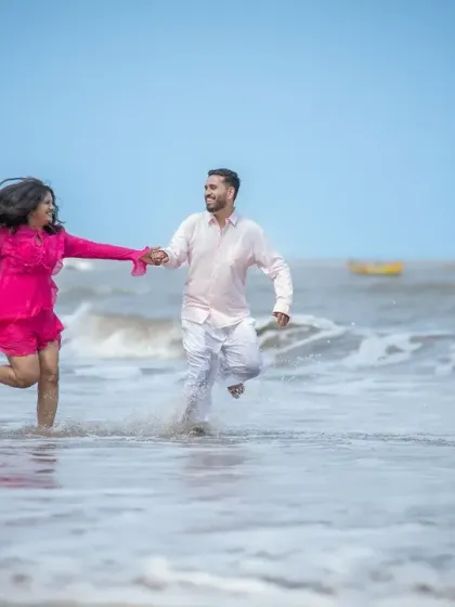Running together on the beach, hand in hand. This is a classic pre-wedding shot that feels energetic, romantic, and full of life.
