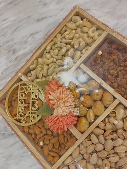 A close up of the floral decoration and 'Happy Diwali' tag on the dry fruit box. The combination of textures is so elegant.