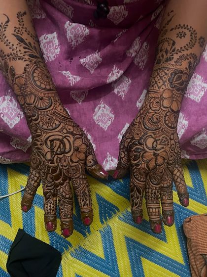 This engagement mehndi features the couple's initials hidden within the design. It's a beautiful way to personalize your henna for the special occasion.