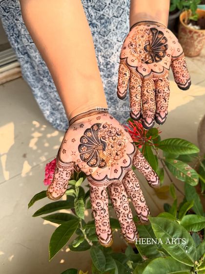 A beautiful and modern take on the peacock motif, designed to look like a delicate piece of jewelry on the hand.