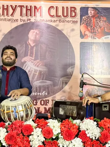 A candid moment of musical exchange with harmonium accompanist Jyotirmoy Banerjee during my solo.