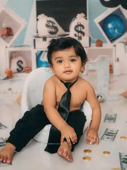 This little guy is the epitome of cool, sitting back and relaxing in his office. A perfect shot from his Boss Baby themed first birthday.