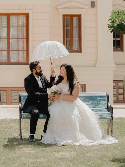 A sweet moment under an umbrella on a sunny day. This photo captures a classic, romantic movie vibe.