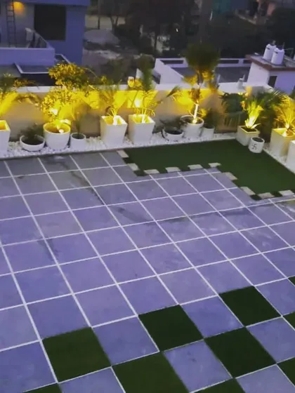 A wider view of the illuminated planters, showing how they can transform a large, plain tiled terrace into a sophisticated space.