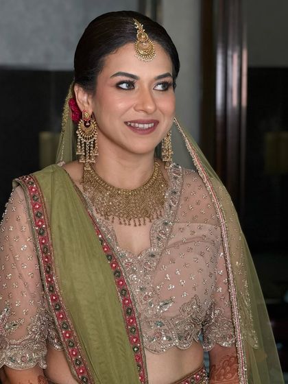 A candid, smiling shot that captures her light eyes and the beautiful way the makeup enhances them.