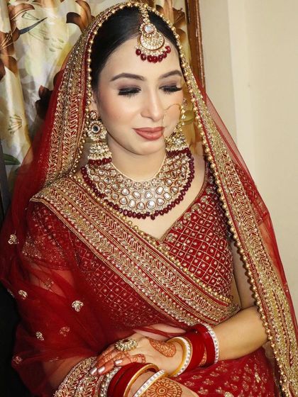 A close-up with eyes closed, highlighting the smokey eye makeup and the flawless base.