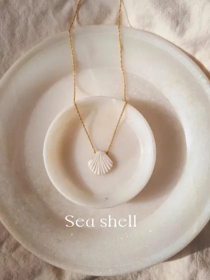 My 'saṅkha' howlite shell pendant, a simple and elegant charm. I use howlite for its healing benefits, particularly its ability to bring patience and calm.